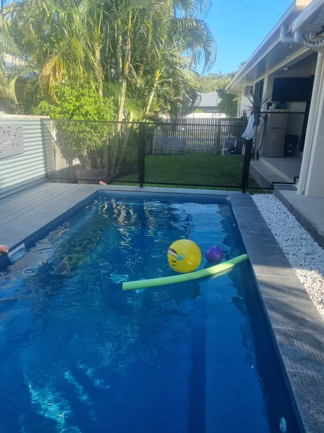 A narrow plunge pool with a black PurePerf fence at the far end