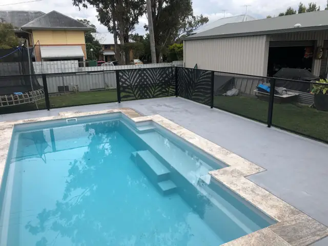 Black Palmy Perf design panels behind a bright pool with steps