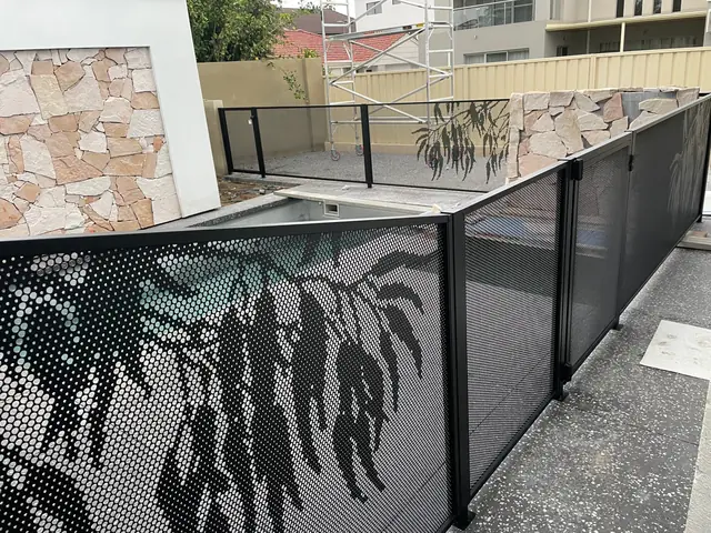 A close view of a black Gum Perf design panel, with gum leaves cut into it
