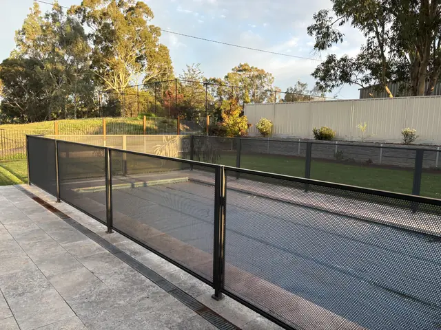 A long run of Monument PurePerf beside a covered pool and a lawn