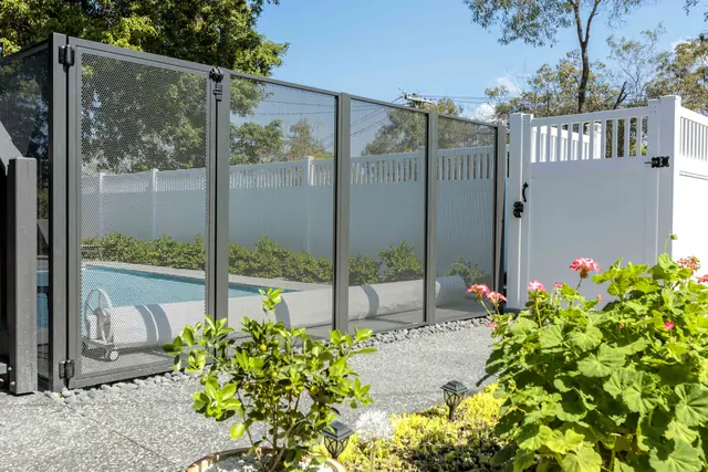 Tall Monument PurePerf panels beside a white fence, with a pool behind