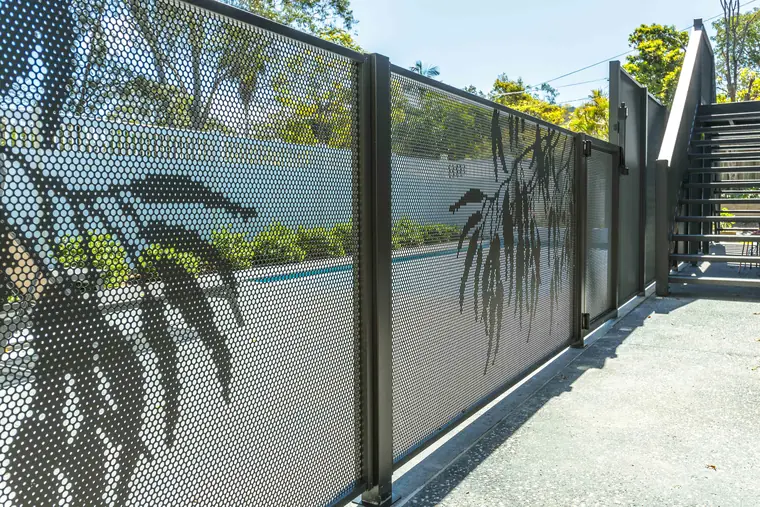 Tall Textured Monument PoolPerf panels with a Gum design, running beside a pool and up to an outdoor stairway