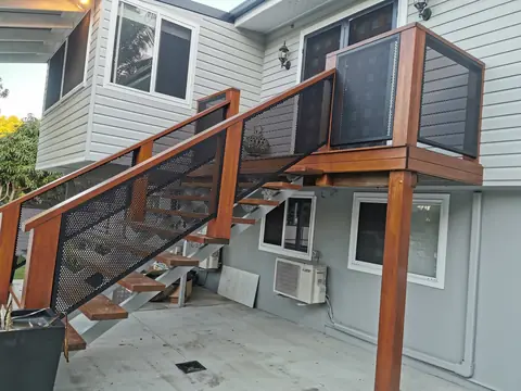 Textured Monument PoolPerf panels set into a timber staircase rail, each cut on an angle to follow the stairs