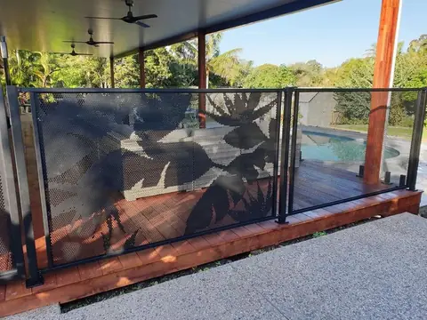 Black Banana in Paradise panels around the edge of a covered timber deck, with the pool beyond