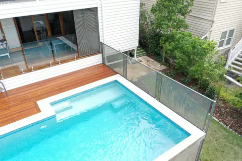 Textured Ironstone Gum design panels and glass around a pool beside a timber deck