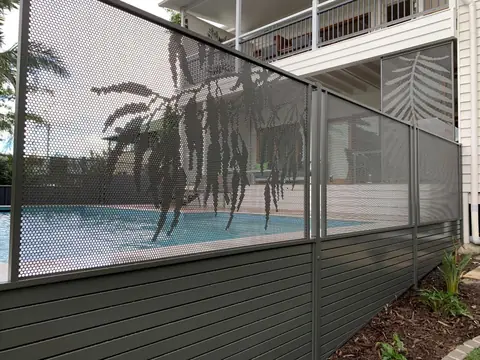 Monument grey Gum design panels along a pool beside a Queenslander