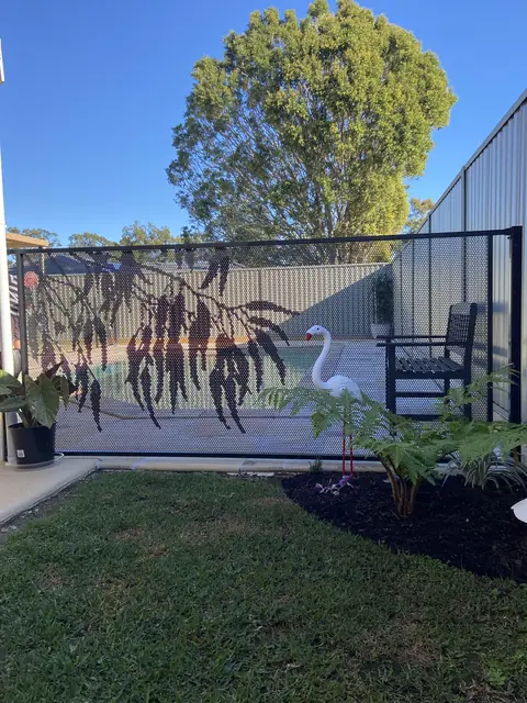 A pale Surfmist Gum design panel beside a lawn, the leaves standing out in shadow