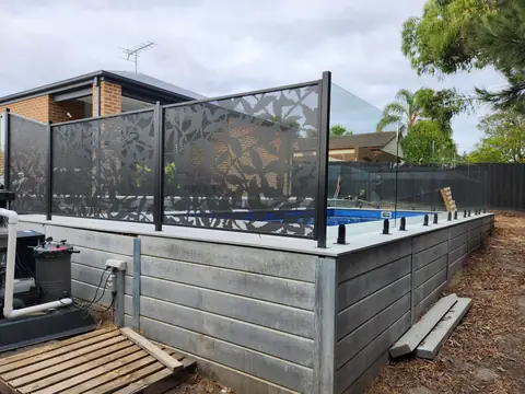 Monument grey Ficus design panels on top of a raised pool wall in Victoria, with glass at the far end