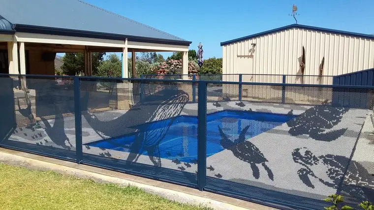 Deep Ocean blue PoolPerf panels with turtles and dolphins cut into them around a Queensland pool