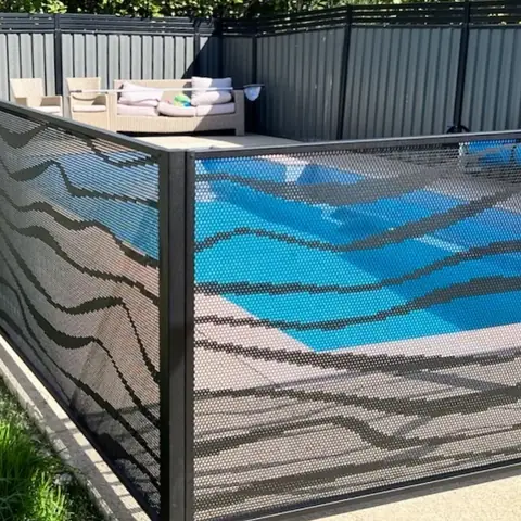 Black Wave design panels around a pool, seen side on so the waves line up from panel to panel