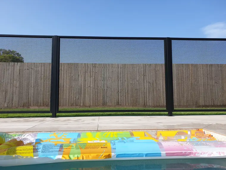 The black PoolPerf side of the same pool after the same swim, with pool toys in the water and nothing on the panels