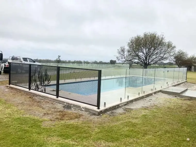 A Gum Perf design panel and a glass panel around a pool on a country property