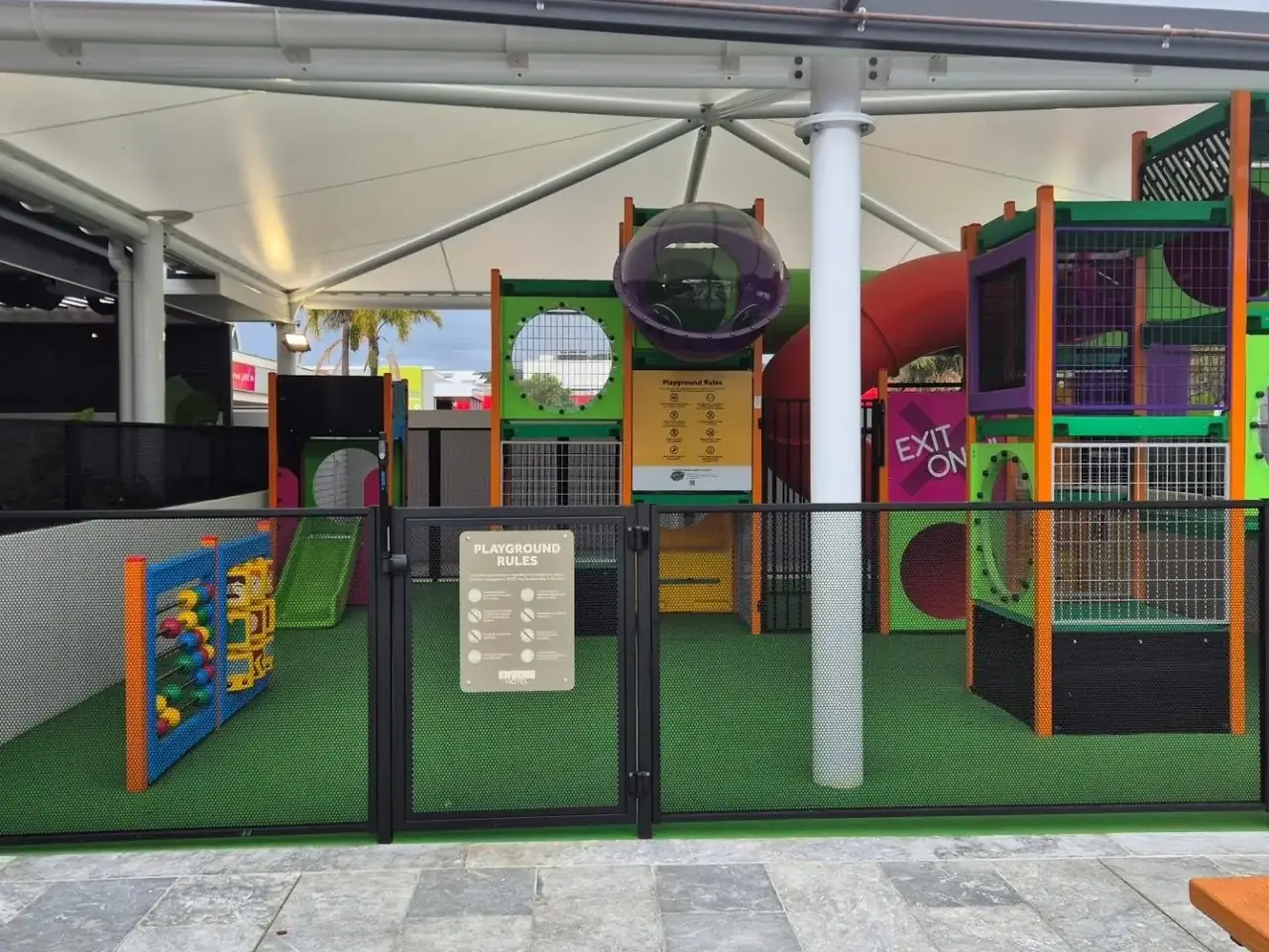 A black perforated gate into the children’s play area at the Swansea Hotel
