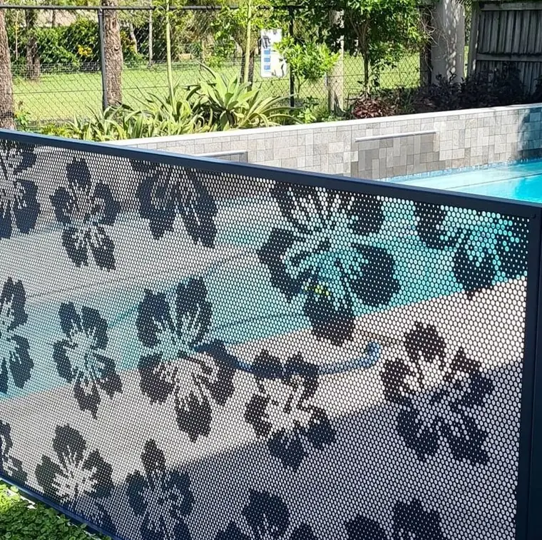 A Hibiscus design pool fence in Textured Deep Ocean, the pool visible through the flowers