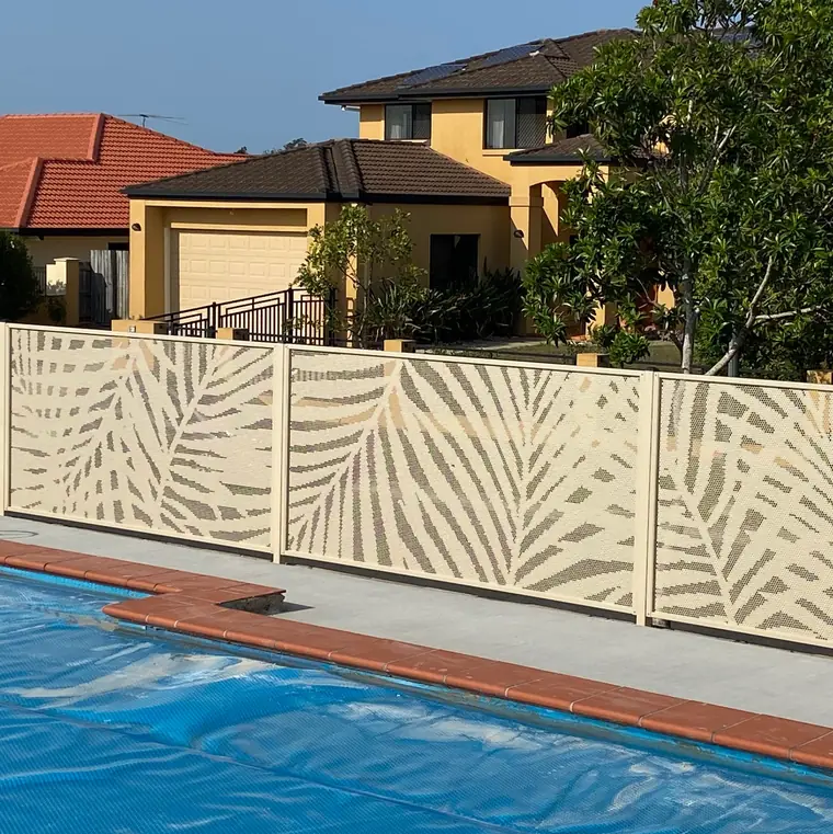 A Palmy design pool fence in Textured Primrose beside a pool