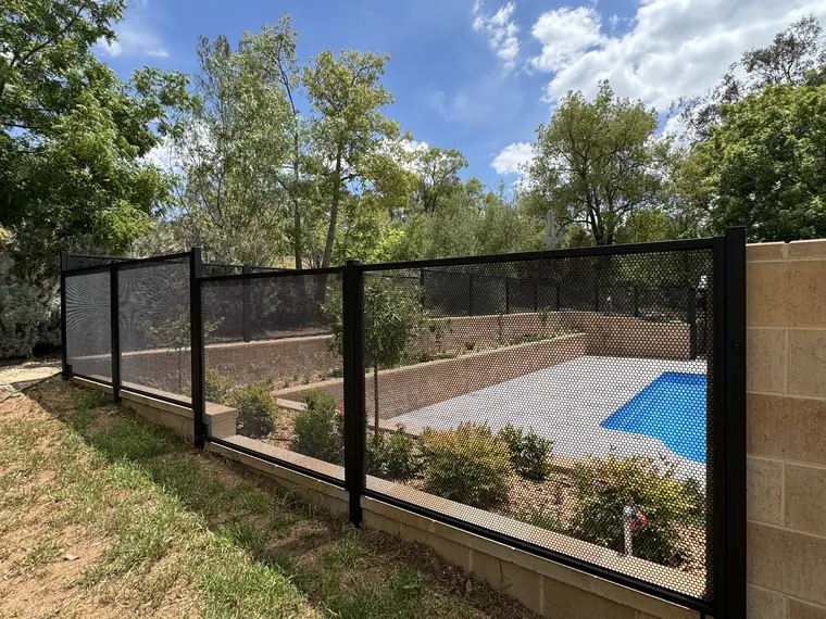 Black PoolPerf panels in New South Wales stepping down in levels along a retaining wall, with the pool below