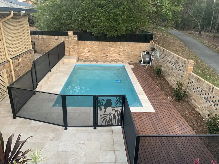 Looking down on a small pool with a black PurePerf fence and a gate with a kookaburra on a gum branch