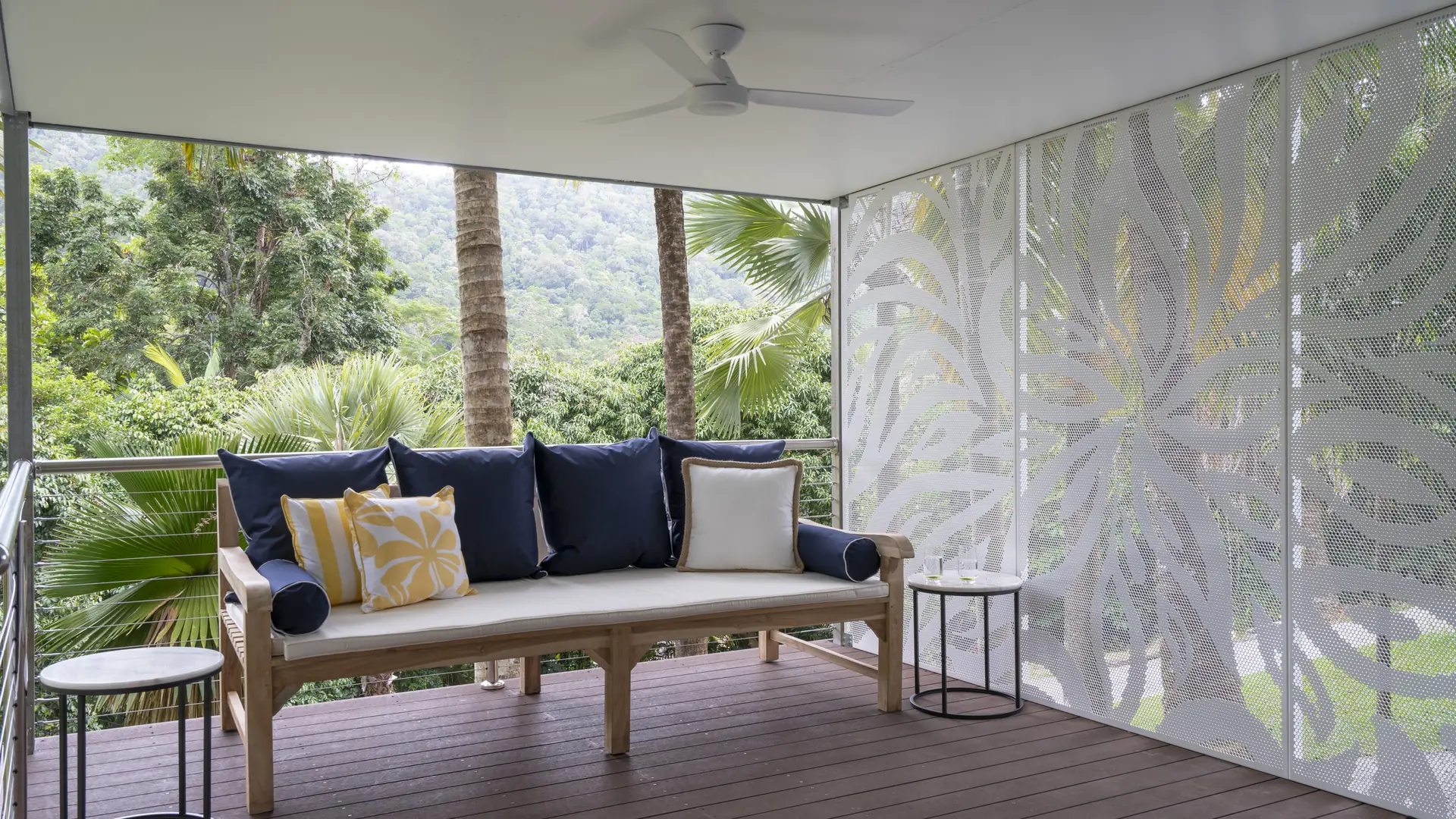 A white Decoview decorative screen on a covered deck, with a view to the hills beyond