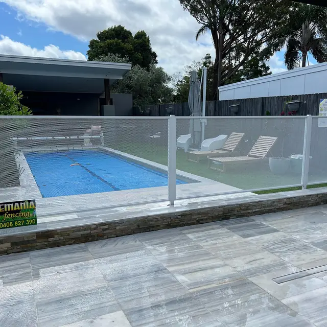A white Pure Perf pool fence beside a pool and new paving