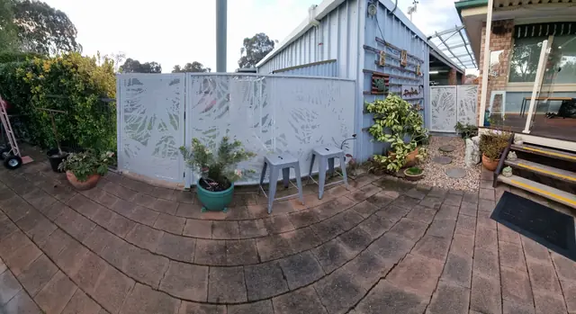 White Pandanus design panels around a paved courtyard