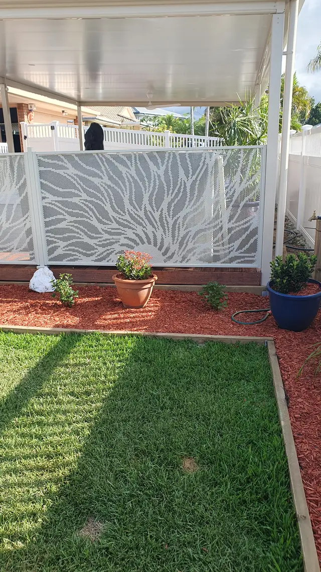 White Sun Rays design panels around a garden bed and lawn