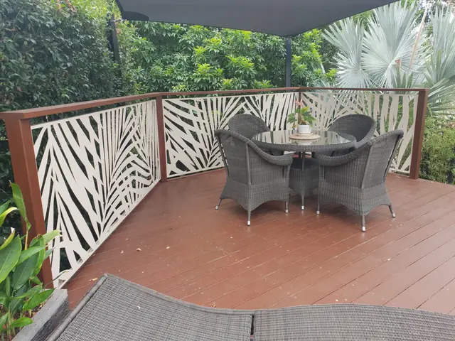 White Palmy design balustrading around a timber deck with outdoor furniture