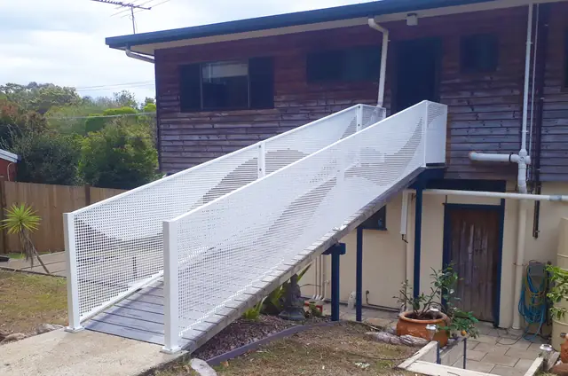 White perforated balustrading on a long access ramp