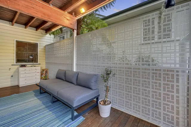 White Nahosh design screens around a covered outdoor room